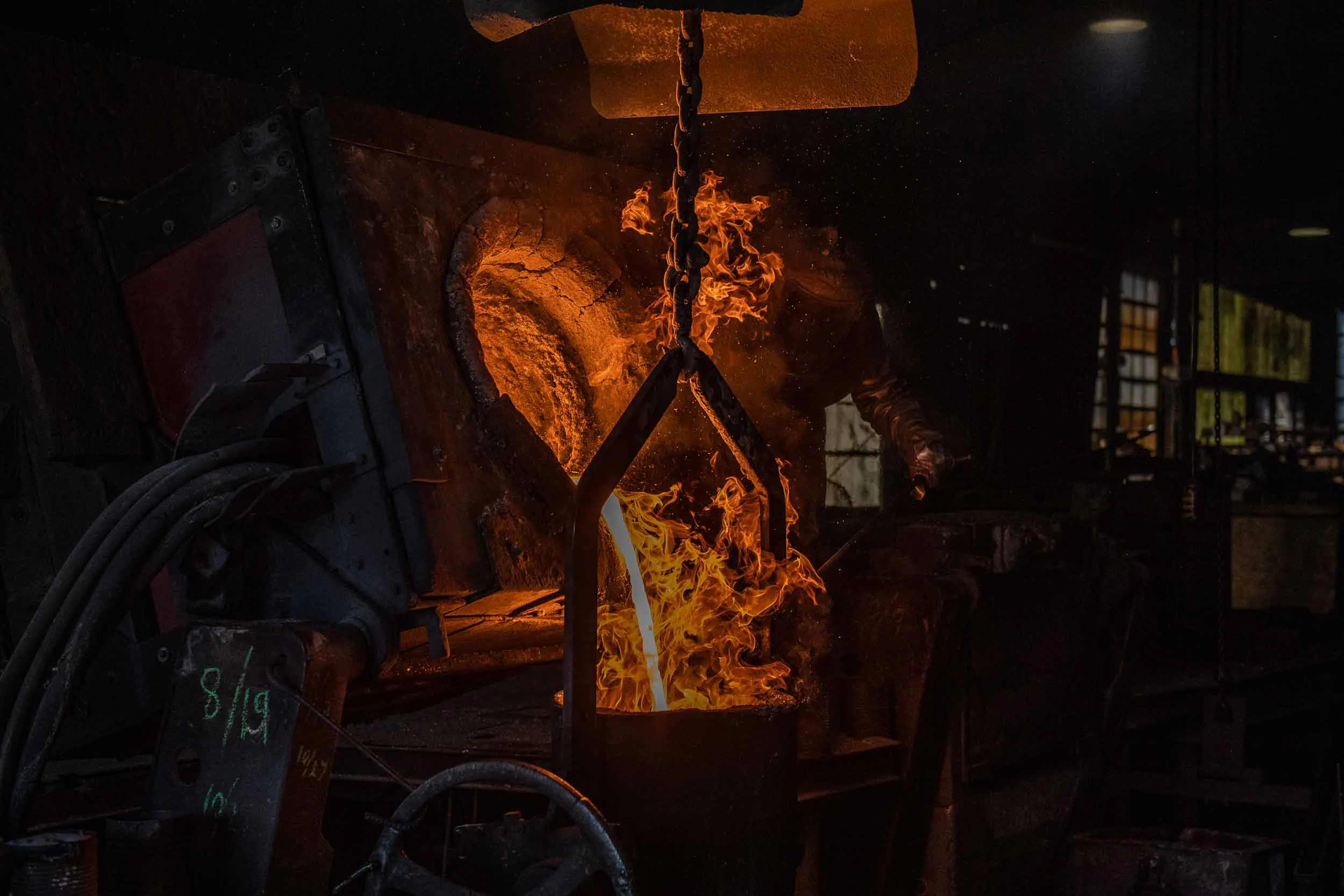 Molten iron flowing into the bucket for pouring